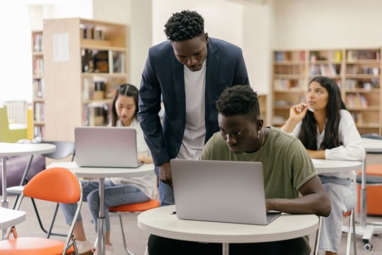 College students learning in a classroom with laptops, representing retaking the Rice Purity Test over time