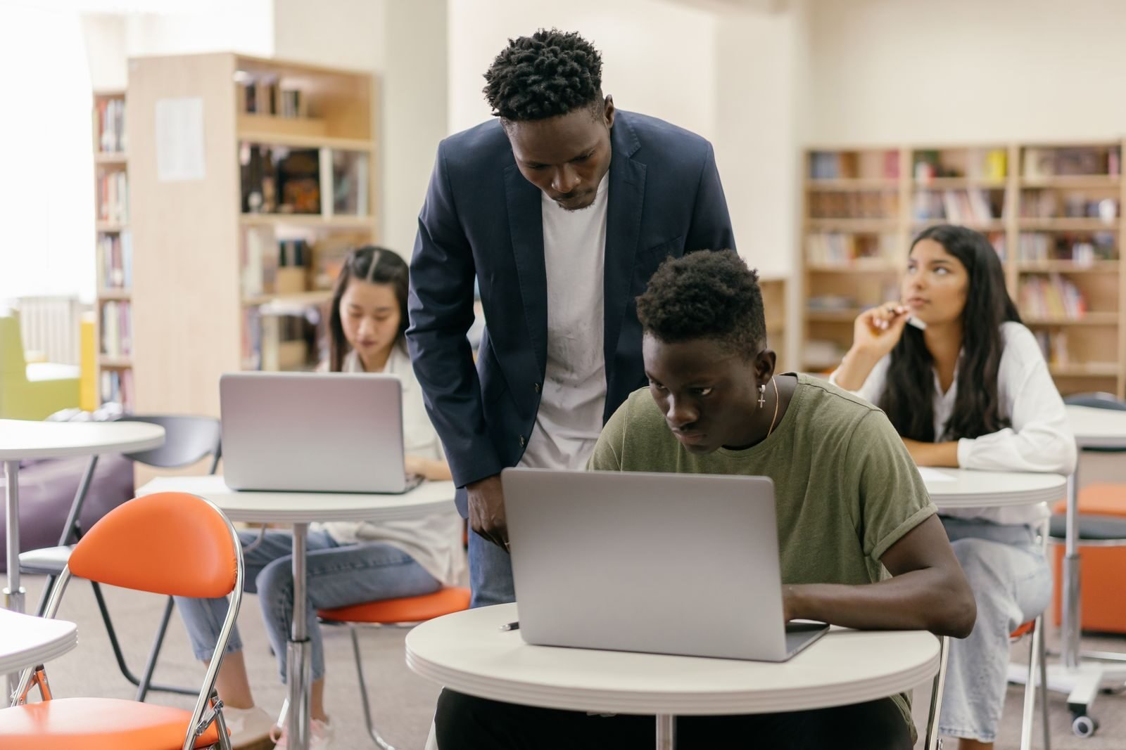 College students learning in a classroom with laptops, representing retaking the Rice Purity Test over time